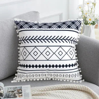Bohemian national style throw pillow cushion cover in light grey on a sofa.