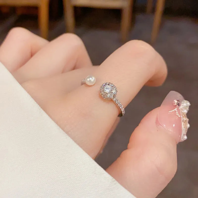 A simple geometric open-end ring with a round zircon stone, shown in gold and silver plated finishes.