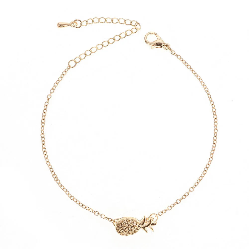 Women's alloy bracelet with pineapple fruit charm in gold or silver finish showing adjustable closure