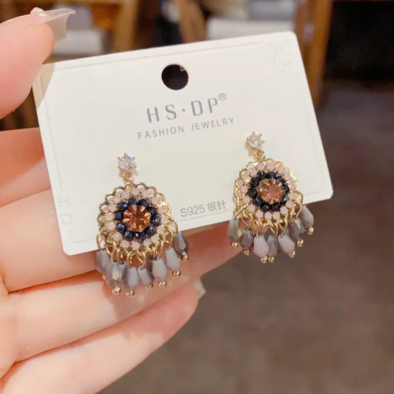 Round crystal tassel earrings with diamond embedded design and thick gold plating in blue or purple colour options