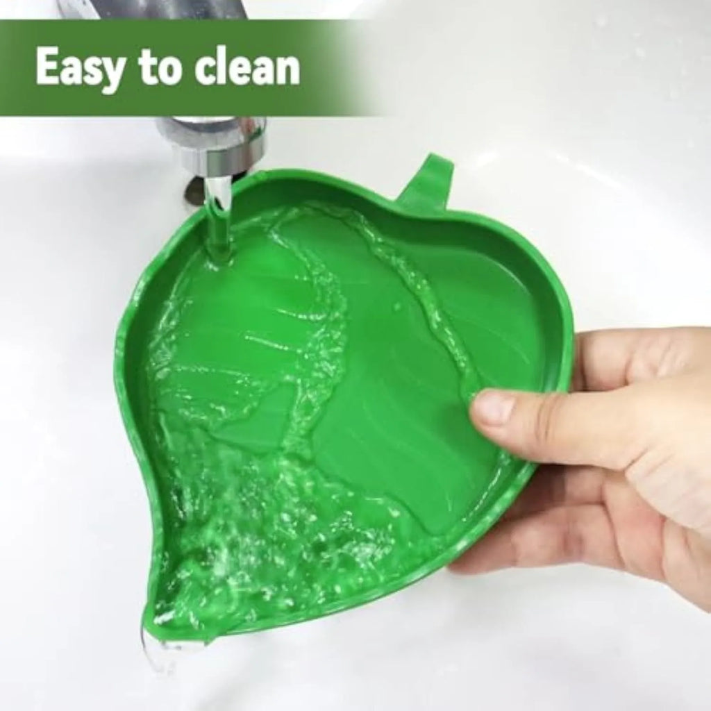 Two leaf-shaped reptile food and water bowls in green, large and small, on a white background.