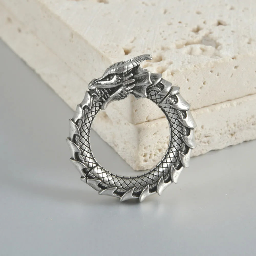 Large geometric dragon-shaped earrings in antique silver stainless steel alloy.