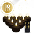 Set of four small black LED tealight candles showing their size and flameless design.