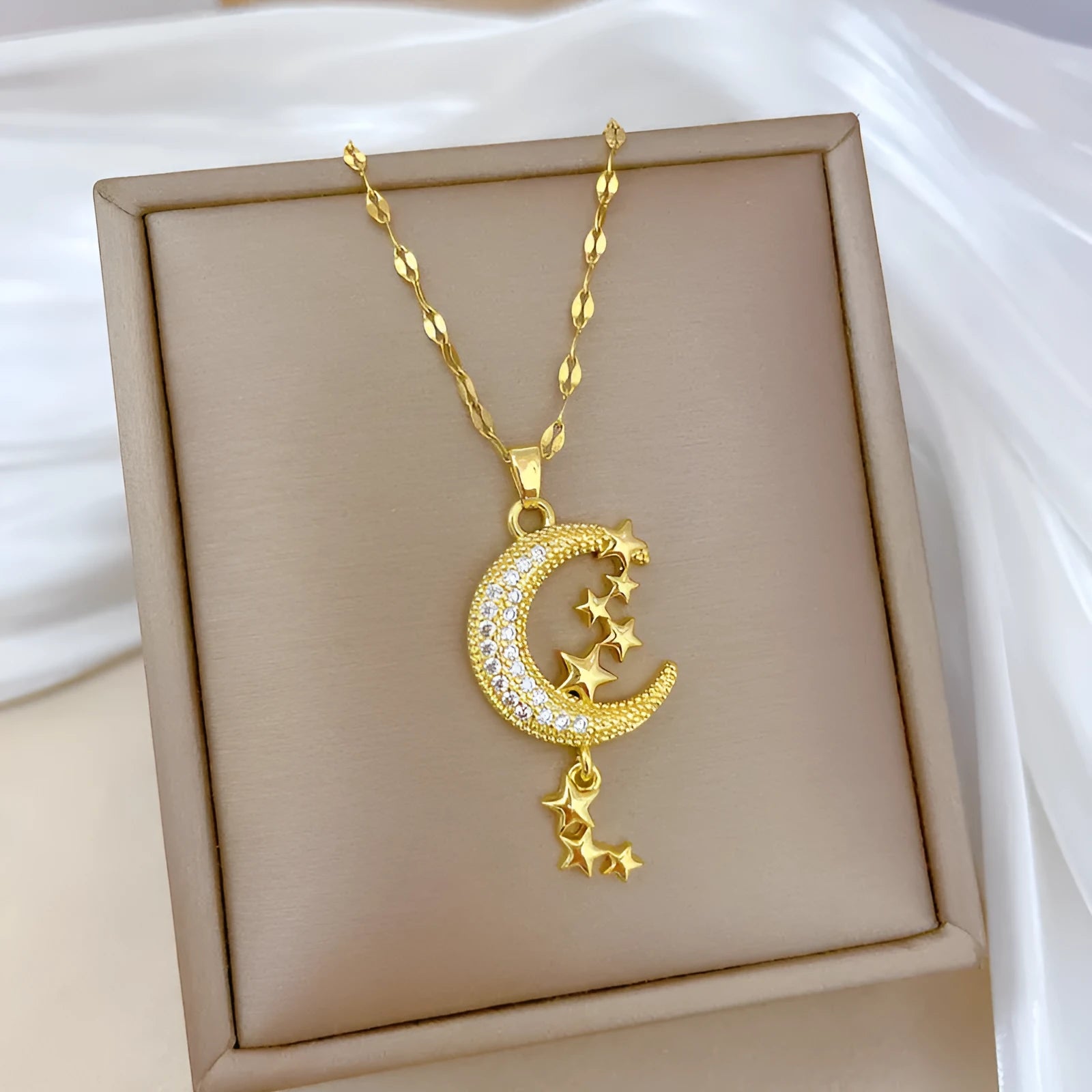 Geometric moon pendant necklace on a stainless steel chain with a copper accent.