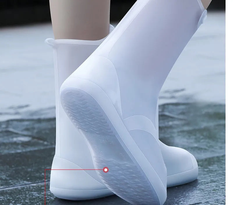White PVC high-top reusable shoe covers for women, shown on feet.