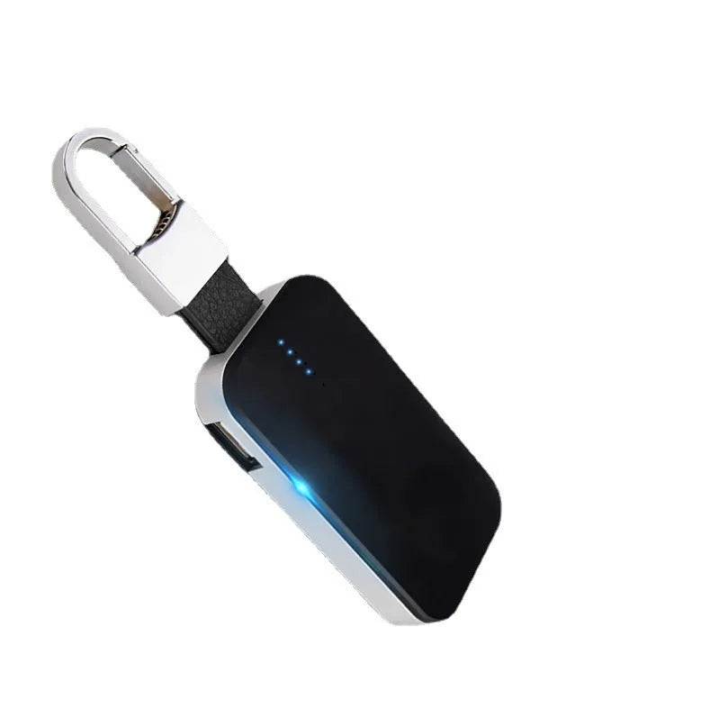 Black Apple Watch wireless charging power bank on a keychain, showing compact size.