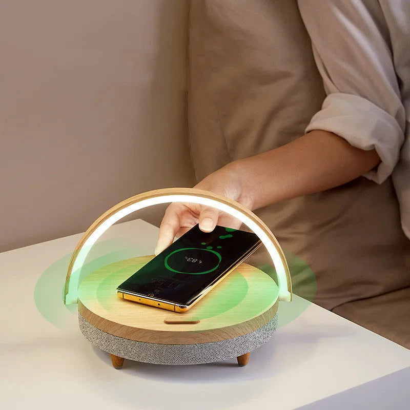 Wireless charging LED night lamp with Bluetooth speaker in marble pattern finish showing phone on charging surface