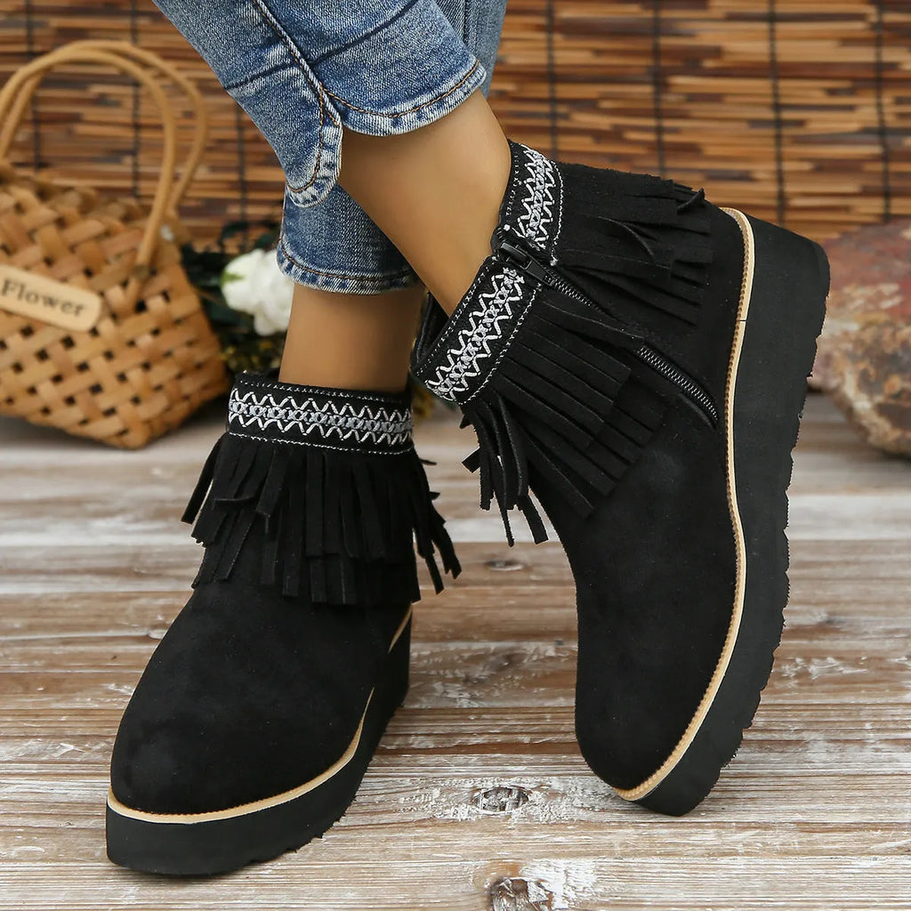 Women's dark brown suede wedge ankle boots with a side zipper and decorative tassels.