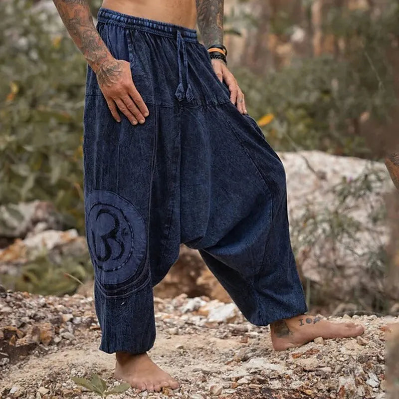 Dark green men's trousers with ethnic pattern and ankle-tied detail on polyester fabric
