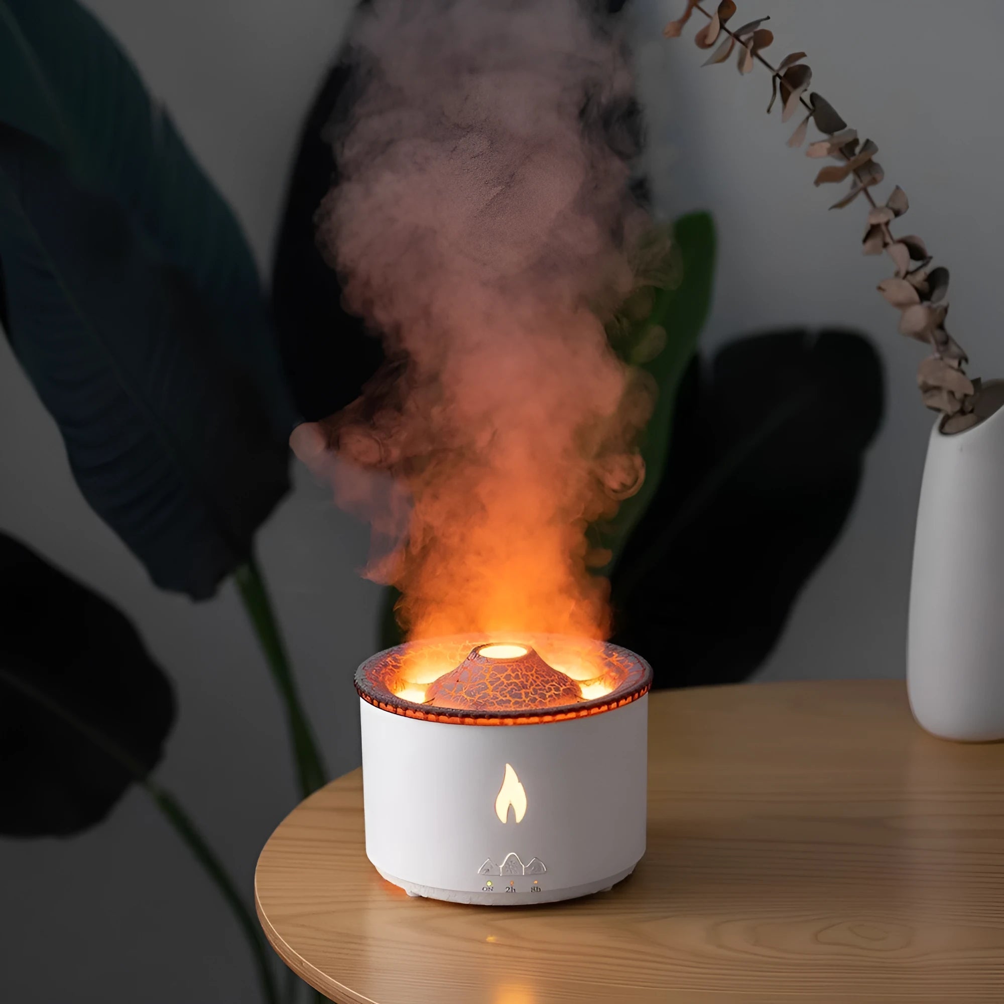 Round two-colour spray ring volcano humidifier with LED lights on a surface