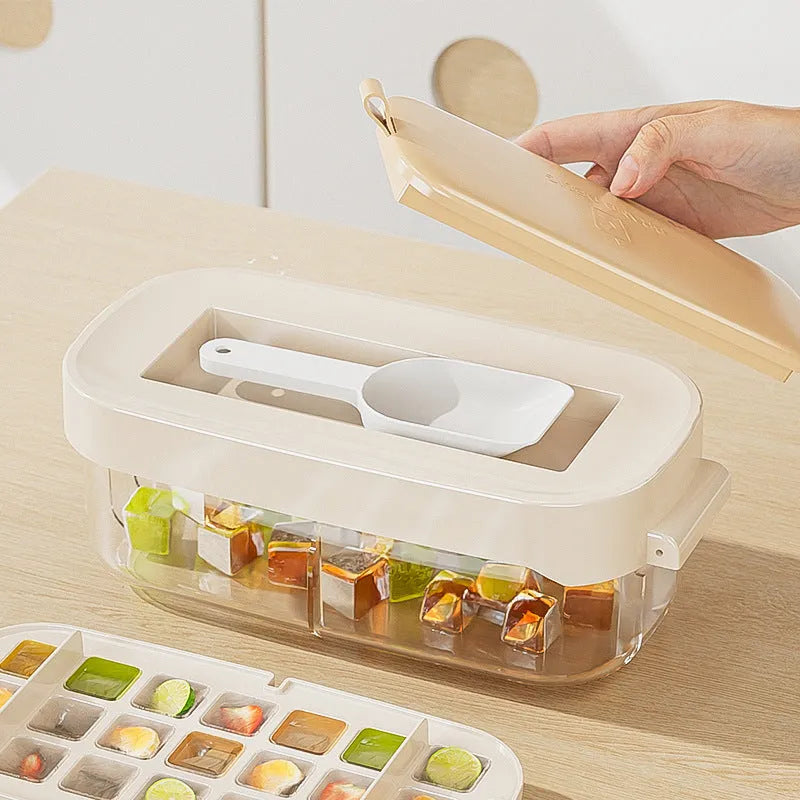 Blue high-capacity ice cube tray with grid design and an ice shovel stored on the side.