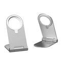 Silver portable magnetic phone bracket for iPhone 12 shown on a car dashboard.