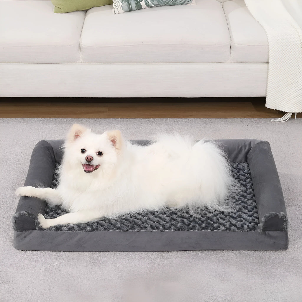 Grey U-shaped dog bed with a removable embossed velvet cover and deep sponge bolster.