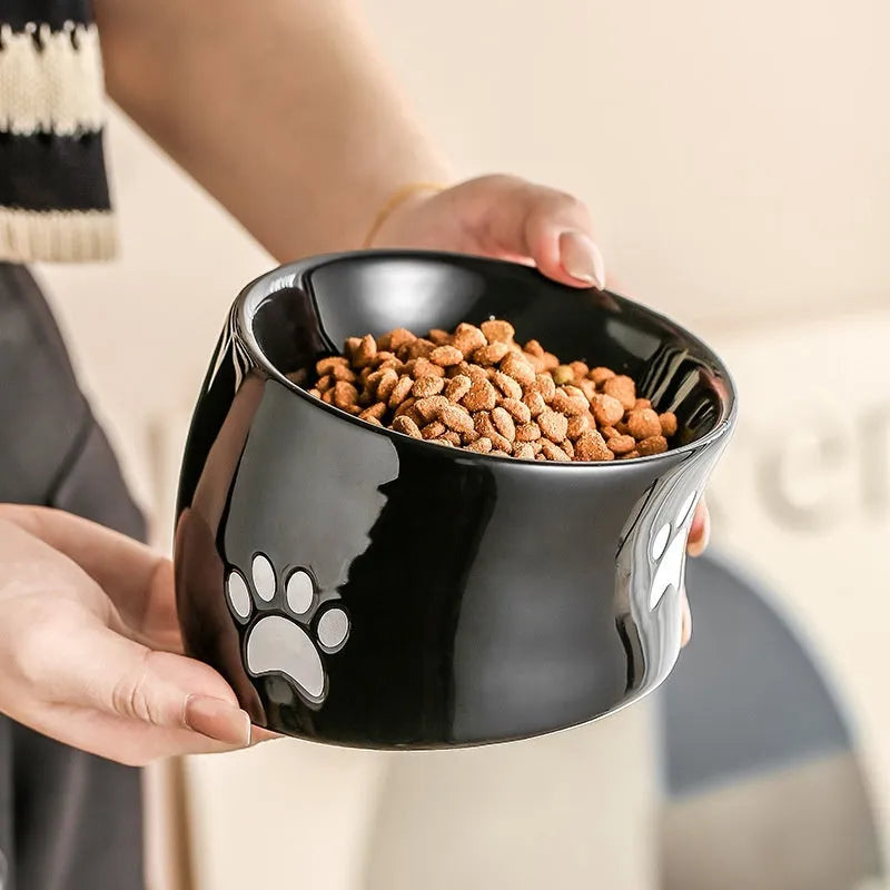 Ceramic cat bowl with high foot design and oblique mouth in cat's paw pattern