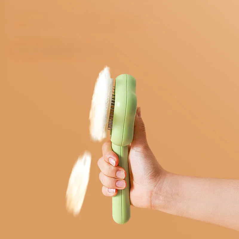 Green or yellow handheld self-cleaning magic wand pet comb with stainless steel needles.