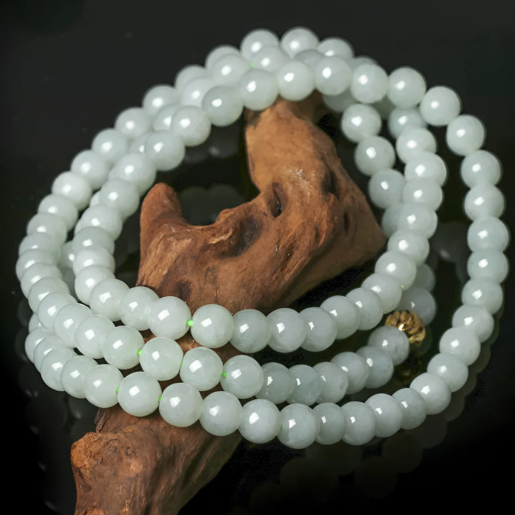 Women's adjustable jade bead necklace with round white green beads on a chain.
