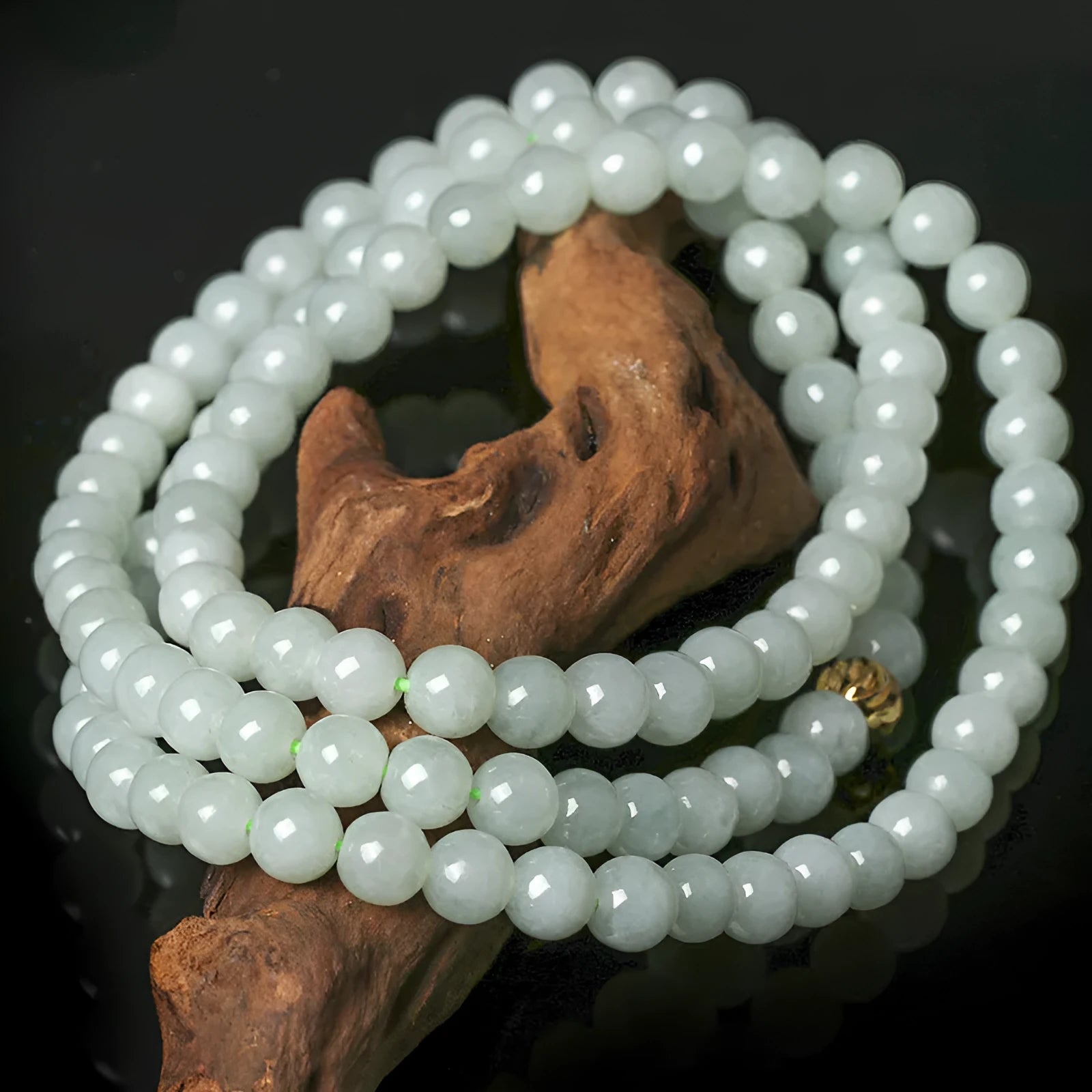 Women's adjustable jade bead necklace with round white green beads on a chain.