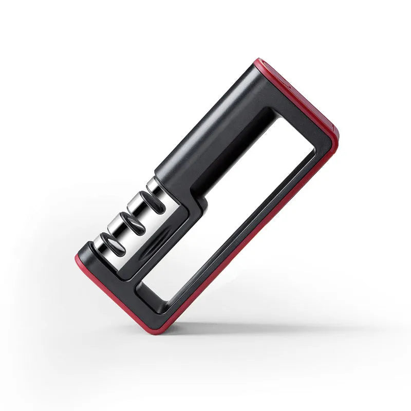 Black and red three-stage professional knife sharpener on a kitchen counter