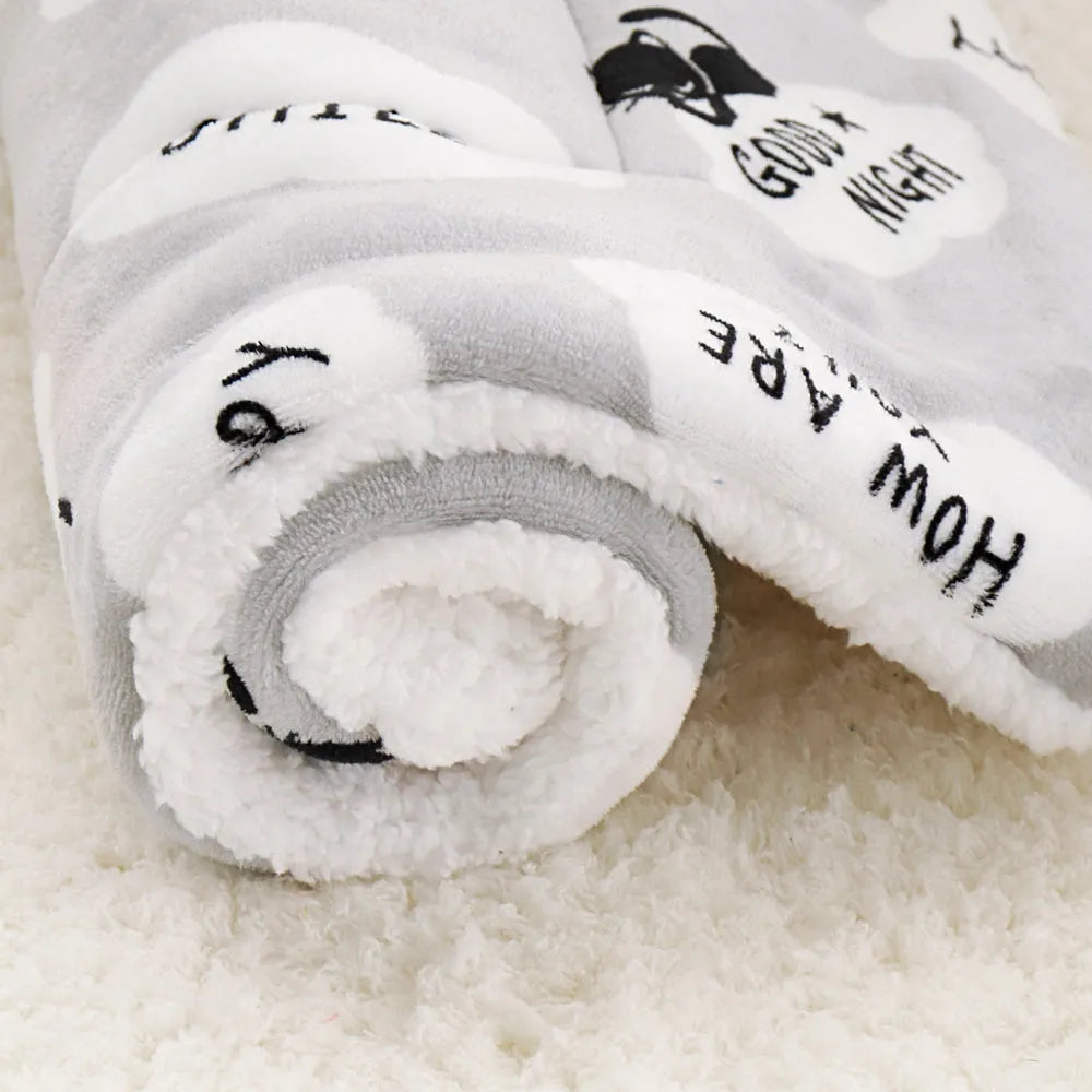 Lambskin pet blanket in flannel cashmere with cute cartoon pattern, grey colour, 55x70cm size on a pet bed