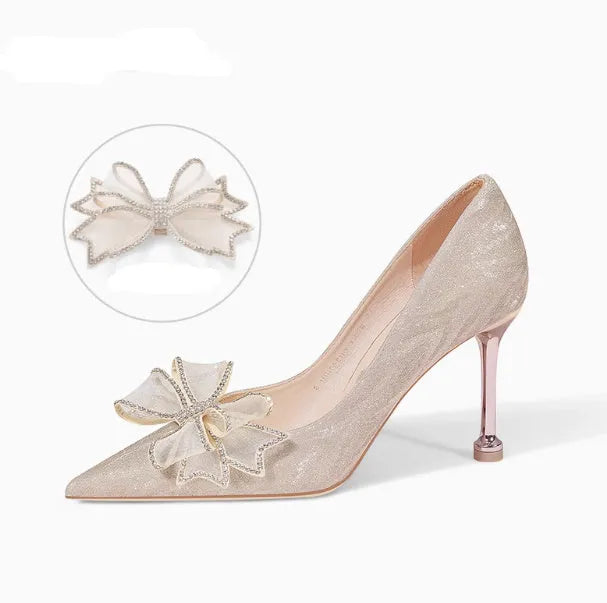 Champagne coloured sequinned pointed toe stiletto high heel pump on a white background.