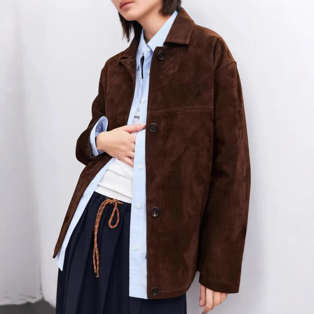 Yellow brown loose fit cashmere coat with a Peter Pan collar and a brown leather belt.