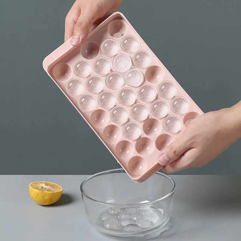 Sky blue and pink 3D round ice cube moulds with spherical cavities