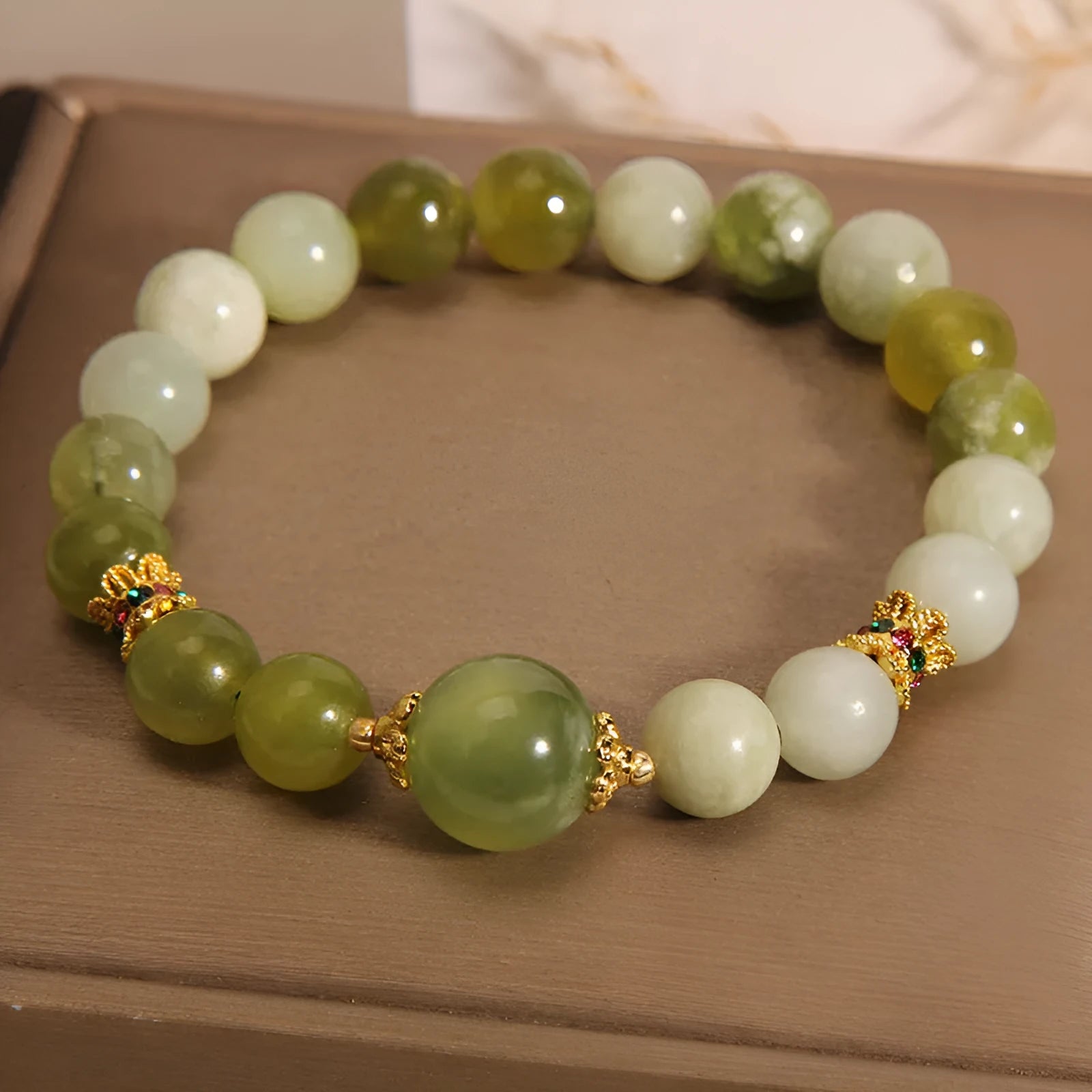 Women's bracelet made of green Xiuyan jade in an original sweet Mori style design.