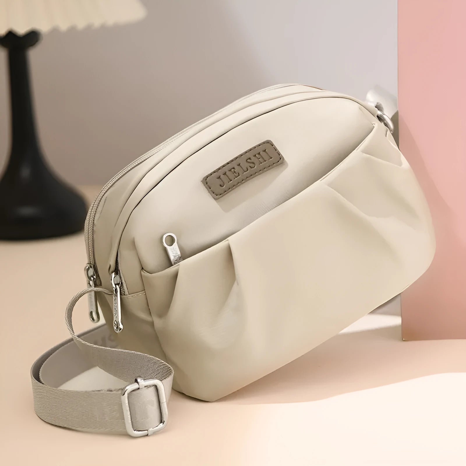 Pleated Oxford cloth crossbody messenger bag in a horizontal square shape with a phone compartment.