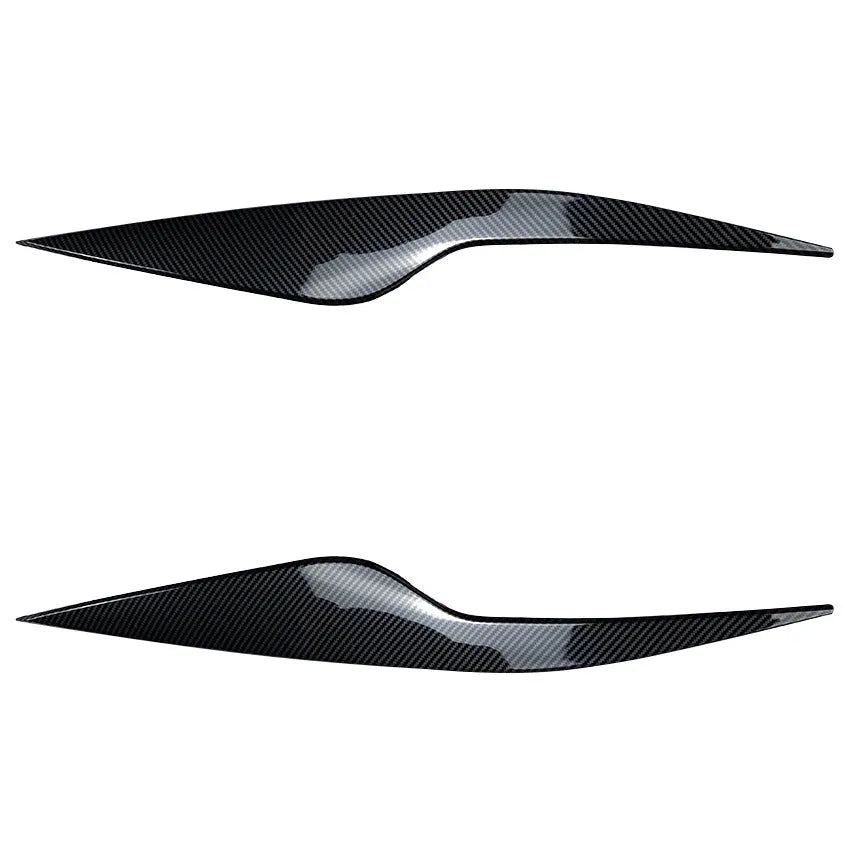 Two ABS plastic headlight eyebrow stickers for Ford Focus in carbon fibre and piano black finishes.