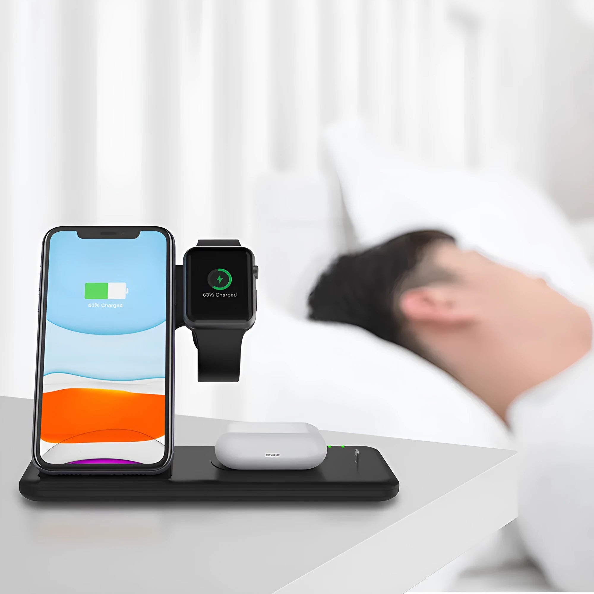 White three-in-one wireless charging stand for mobile phone smartwatch and headset on desktop