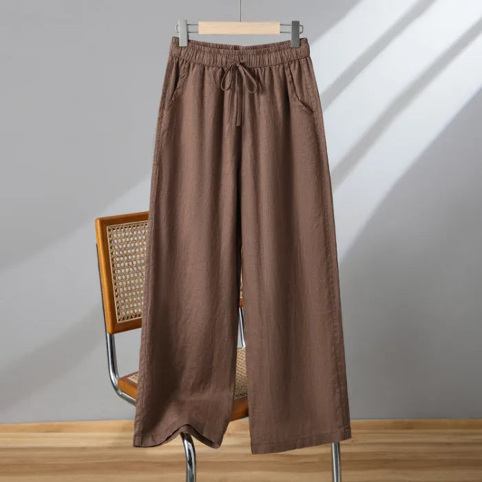 Women's apricot straight-leg casual trousers with elastic waist and front drawstring detail.