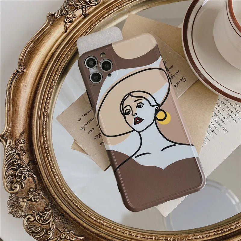 Orange yellow iPhone case with a colourful line painting cartoon design on a soft, textured surface.