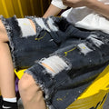 Men's loose fit light blue denim shorts with water washed hole design and fifth pants length.