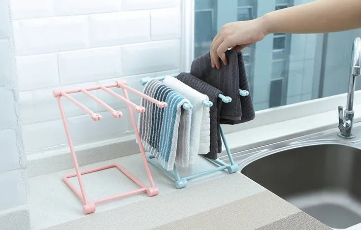 Foldable plastic towel shelf with vertical storage in light pink Nordic kitchen organiser