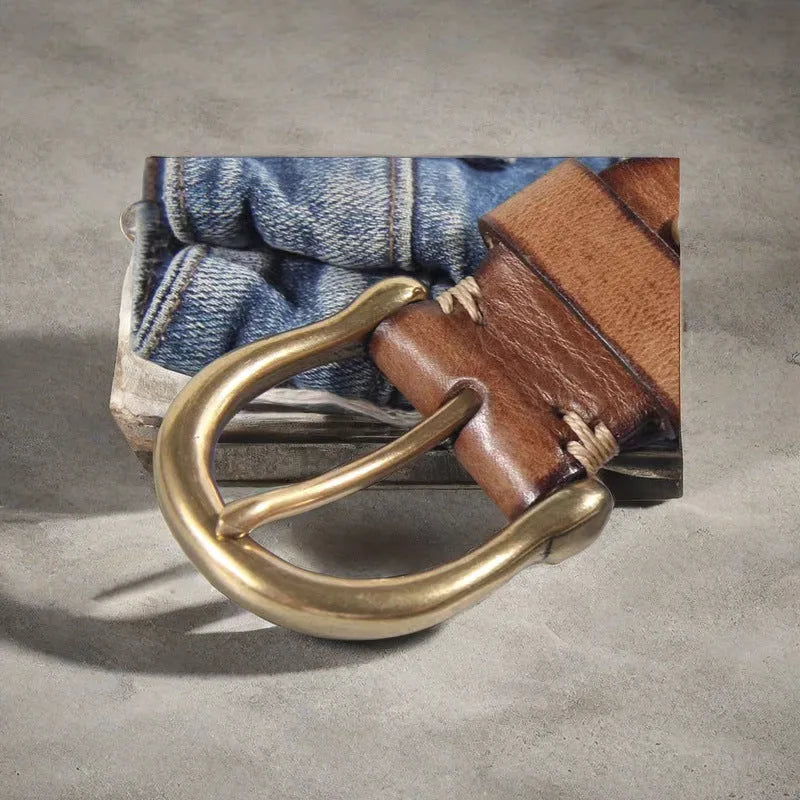 Men's black genuine cattlehide leather belt with a copper pin buckle on a jeans background