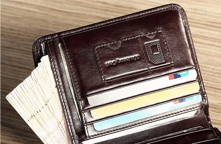 Men's black leather RFID blocking wallet open to show card slots, ID window, and coin pocket.