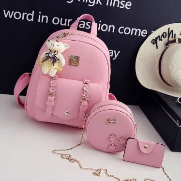 Women's three-piece leather bag set showing backpack, shoulder bag, and card holder with floral patterns