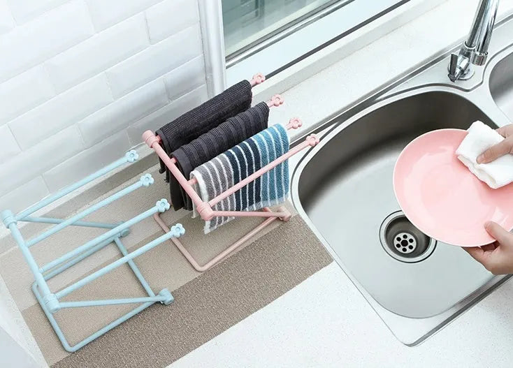Foldable plastic towel shelf with vertical storage in light pink Nordic kitchen organiser