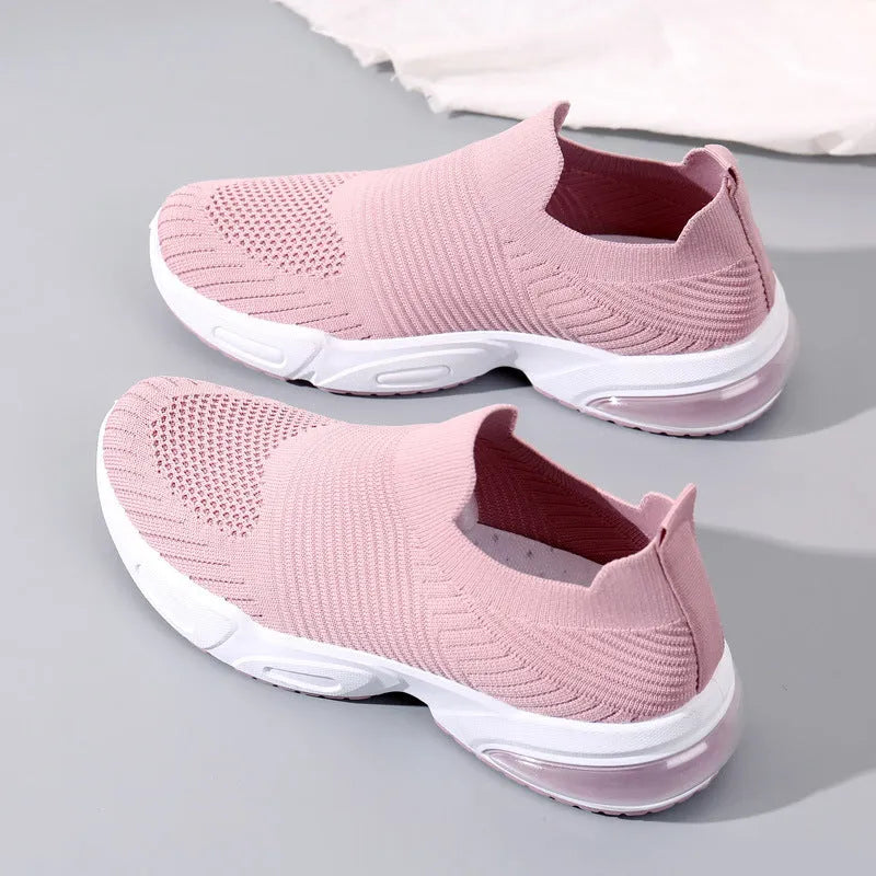 Slip-on breathable sock shoes in black, pink, khaki, and white colours on a white background.