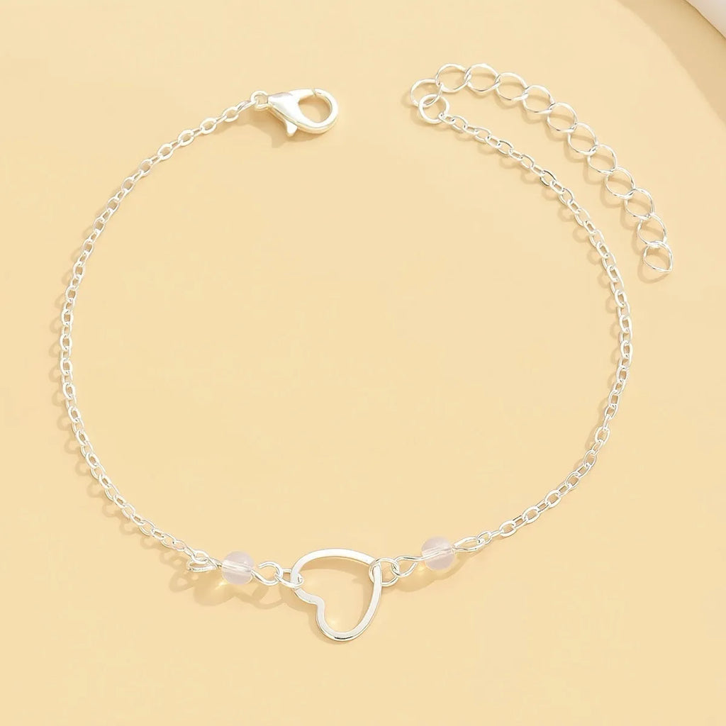 Adjustable women's anklet with heart-shaped pendant in gold and silver alloy finishes