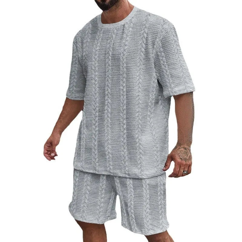 Men's knitted jacquard short sleeve pullover and shorts set in a solid colour on a hanger.