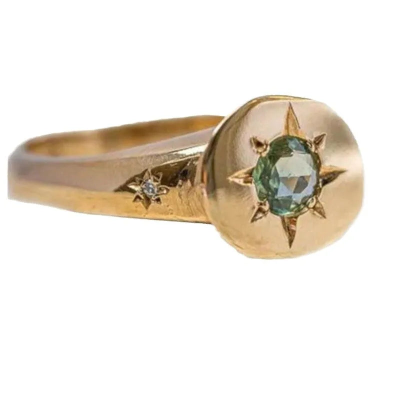 Gold-colour adjustable ring with an oval-shaped star design and central zircon stone.