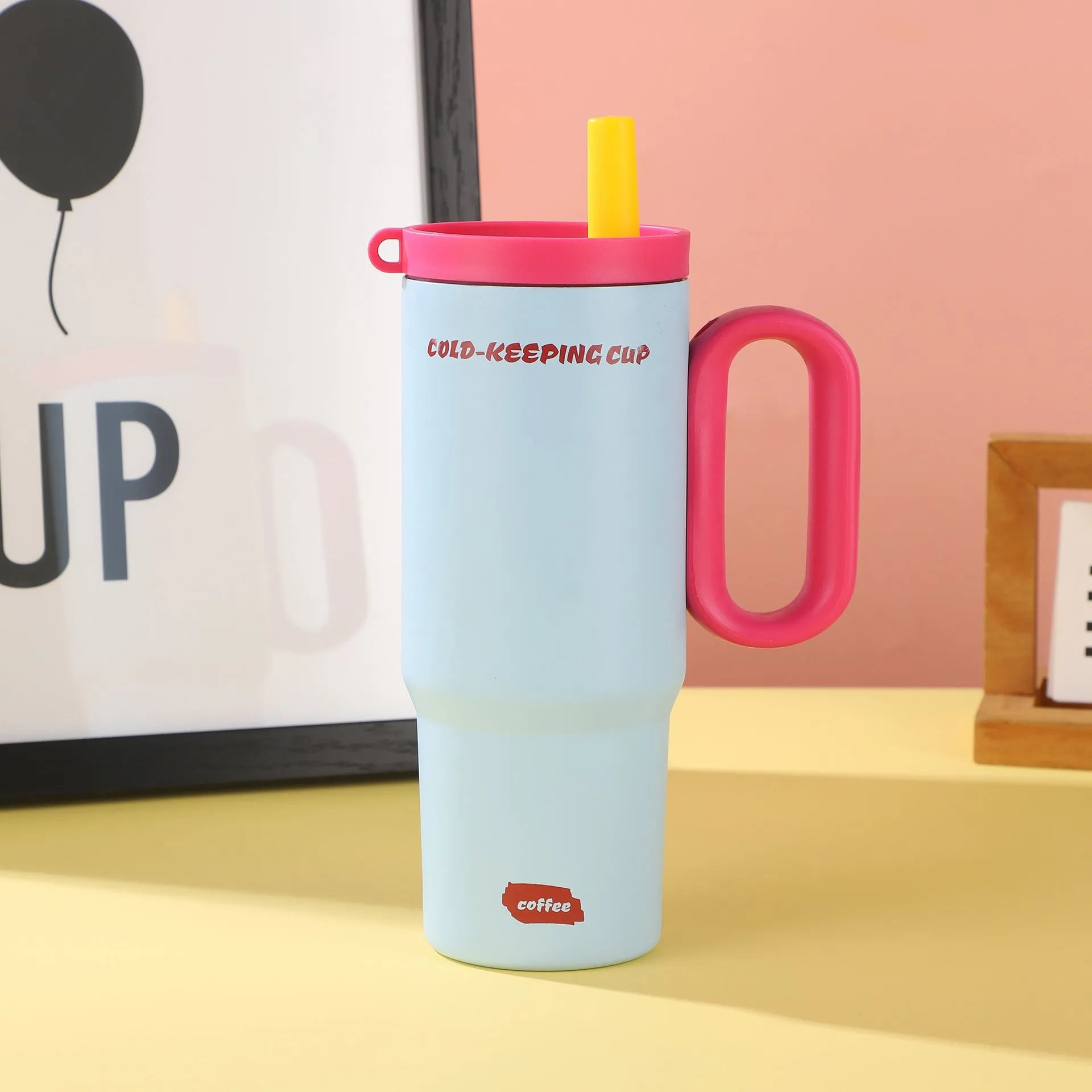 Insulated plastic straw cup with carry handle in five colour options showing 700ml capacity