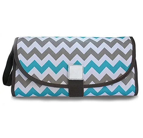 Portable baby diaper changing mat in yellow geometric pattern, 70x50cm, with toy ring and wrist strap unfolded on floor