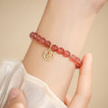 Strawberry quartz glass blessing card bracelet with adjustable clasp on wrist
