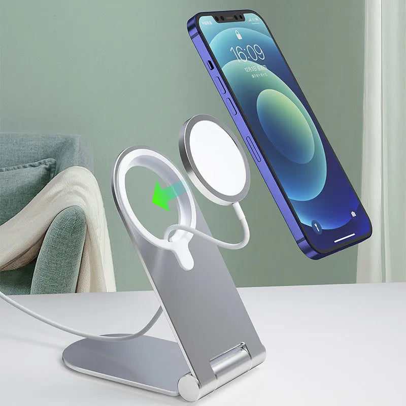 Silver portable magnetic phone bracket for iPhone 12 shown on a car dashboard.
