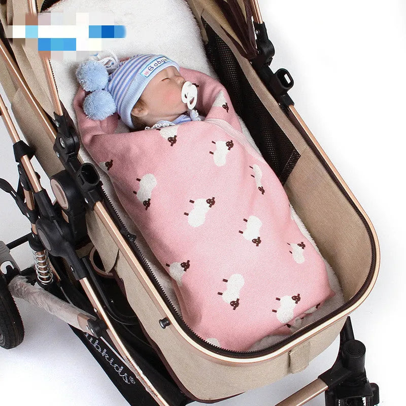 A pink baby sheepskin blanket measuring 100 by 80 cm on a pram.