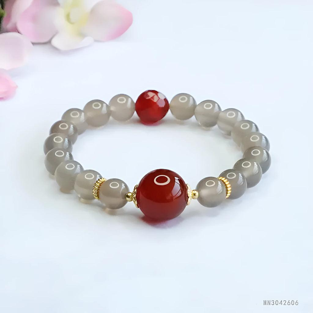 Smoky purple chalcedony red agate bracelet with 8mm geometric beads on a wrist.