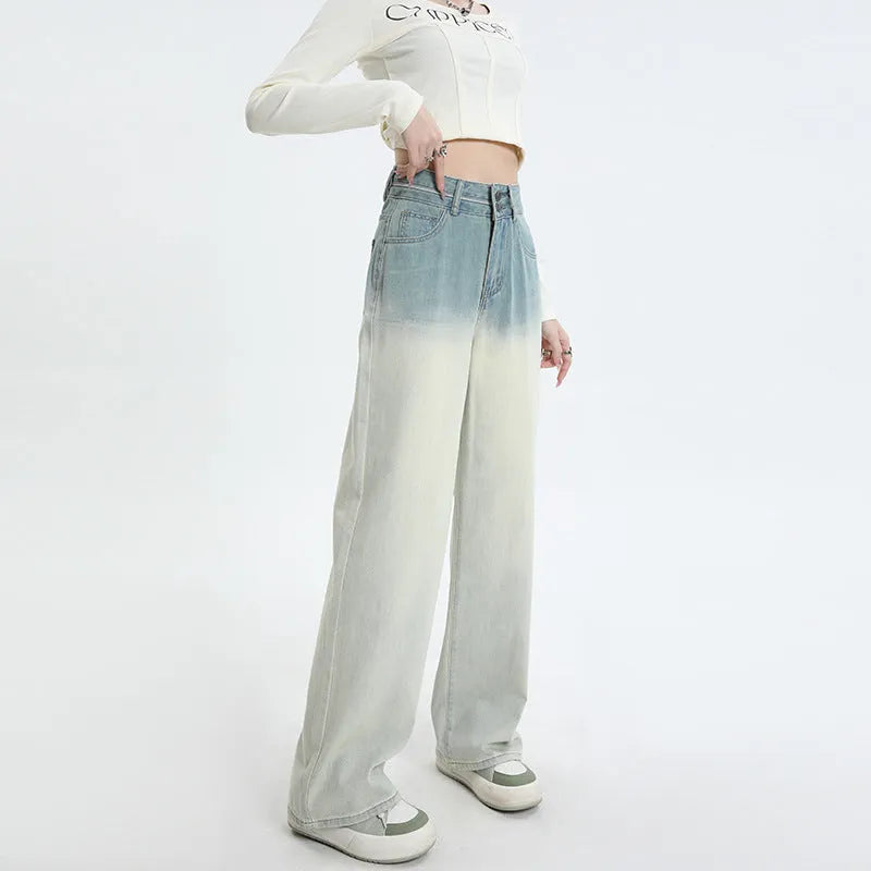 A pair of women's gradient blue wide-leg denim trousers on a neutral background.