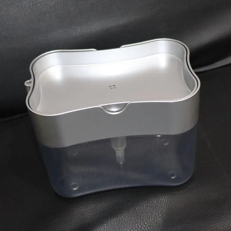 A grey plastic soap dispenser bottle for liquid hand wash on a kitchen counter.